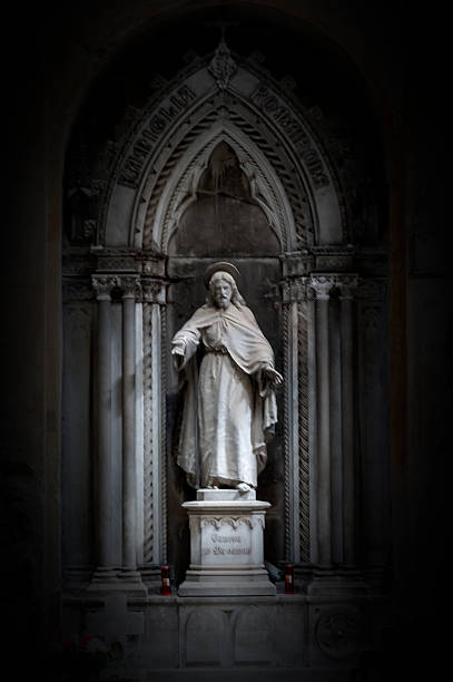 Jesus Christ statue against white background. Black and white vertical image.