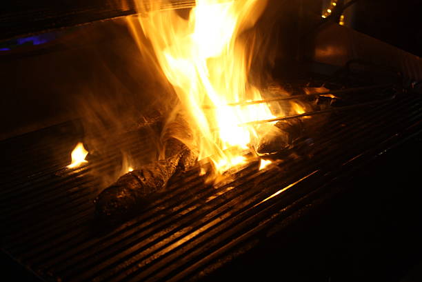 Charcoal burning under a grill at a barbecue.