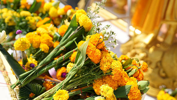 Bright yellow marigold flowers arranged in decorative display, symbolizing celebration and spirituality, often used in rituals and offerings