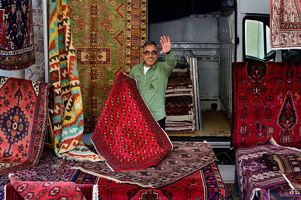 Bassano del Grappa, Italy - September 27 2025: Carpet Vendor Presenting Oriental Rugs at a Market.