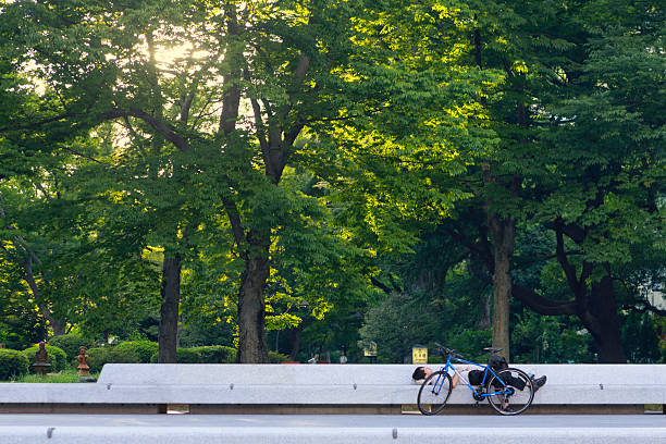 Canyon Country, United States – June 15, 2022: A homeless man resting in street near bicycle
