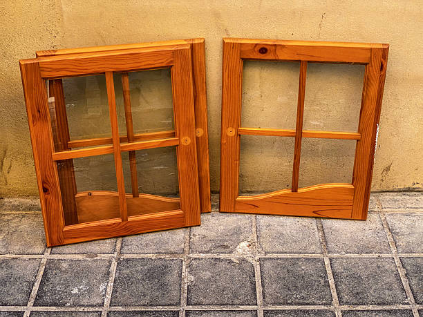 High angle close-up view of wooden window frames abandoned in the street lying over wall