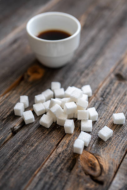 Black Coffee with Sugar Cubes on Wooden Table