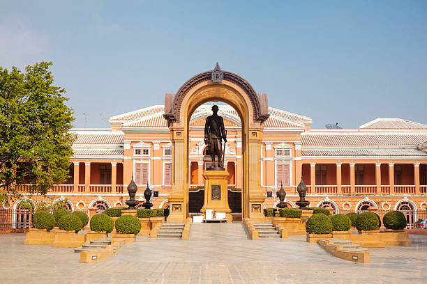 Front view of Saranrom Palace in Bangkok built under reign of King Rama IV.  Palace turnt from palace to the Ministry of Foreign Affairs. Palace is  located in  Phra Borom Maha Ratchawang, Phra Nakhon District in Bangkok. In front of palace is statue of king Rama IV under arch bow.