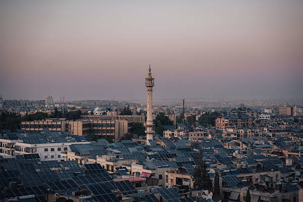 Panoramic city view of Aleppo with a mosque minaret centred among rooftops and residential building