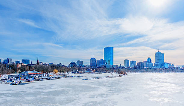 Boston's skyline on a cold February winter day after a snowfall, as seen across a frozen Charles River. The Charles River Esplanade along water's edge and the Back Bay neighborhood are featured.