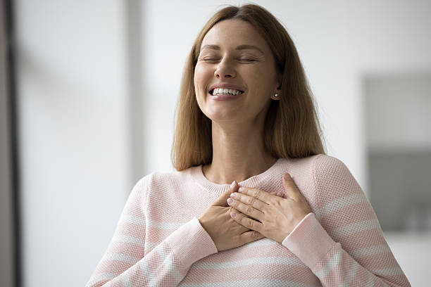 istock Woman put folded palms on chest, feeling thankful express gratitude 2260430788