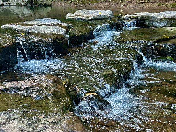 Water flows over rocks in a river in the Appalachian Mountains creating a small waterfall.