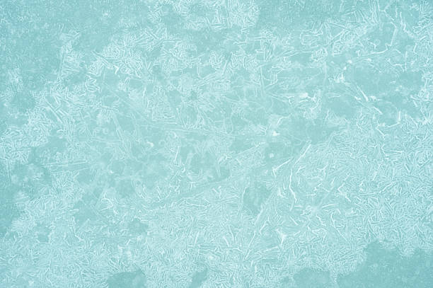 Copy space light blue frozen ice texture background with detailed frosty patterns and abstract winter cold seasonal atmosphere.