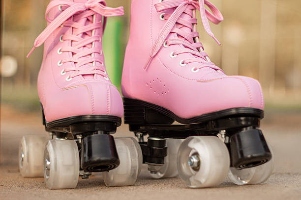 istock Pink roller skates on child legs close up 2260465862