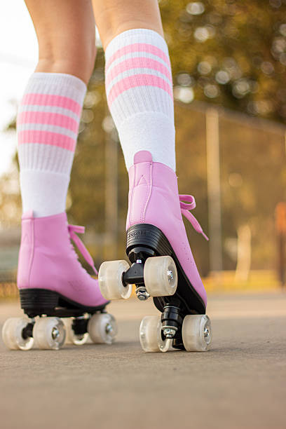istock Pink roller skates on child legs during outdoor skating in spring 2260465866