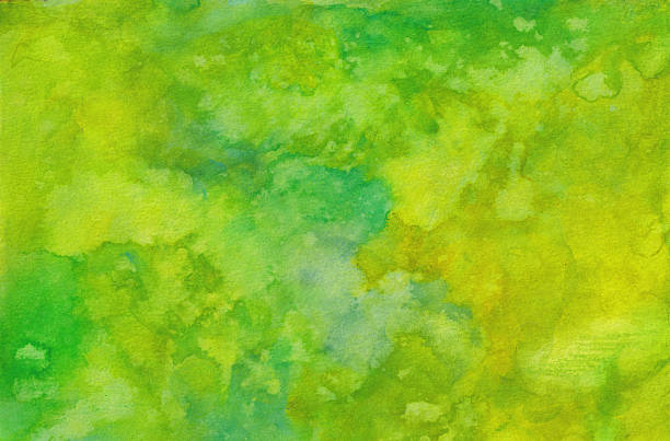 This is an abstract background created using green and yellow watercolors on paper. There is a mottled texture from the blend of colors and water drips. This is a horizontal painting that can be rotated vertical if needed.