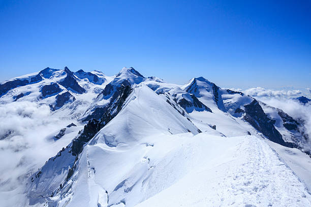Glacier panorama with mountain massif Monte Rosa with summit Dufourspitze (left), mountain Lyskamm (middle) and mountain Castor (right) in summer in Swiss Alps, canton of Valais, Switzerland