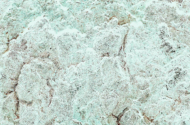 Faded light gray-gray to aqua green rock surface texture with brown cracks (Retouched and color manipulated image)