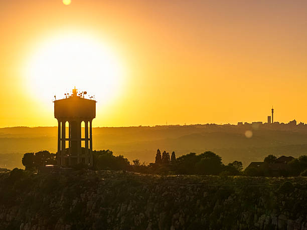 Sunrise on Northcliff Hill Water Tower with a Johannesburg silhouette in the background.