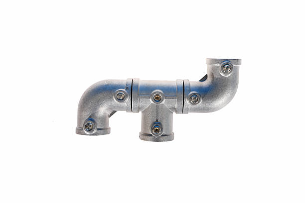 A creative typographic arrangement of cast aluminum alloy modular pipe connectors, including elbows and tees, assembled to form the letter F. The durable, matte-finished components feature pre-drilled screw holes, merging functional industrial hardware with a playful, artistic design against a clean neutral background.