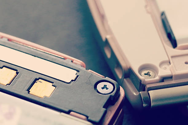 A black flip phone is shown with the flip open. The phone has a keypad and a small screen.