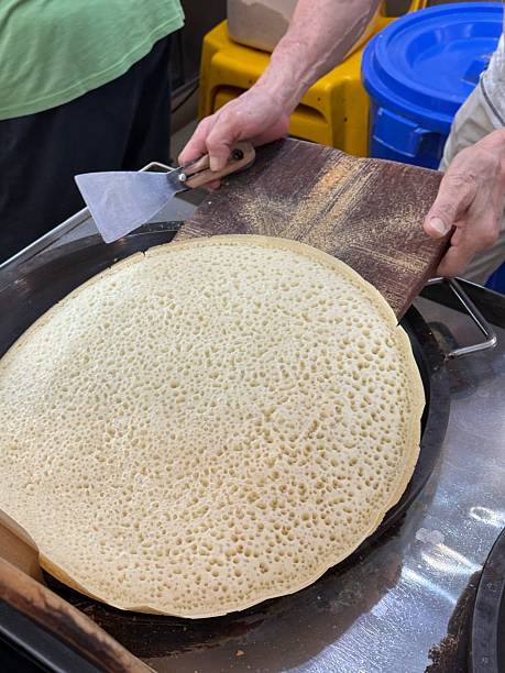 Close-up of adult making pancake