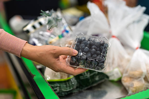 Fresh Blueberries in Plastic Containers on Supermarket Checkout Counter