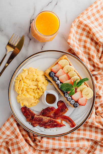 A Delicious Breakfast Plate with Scrambled Eggs and Fresh Fruits