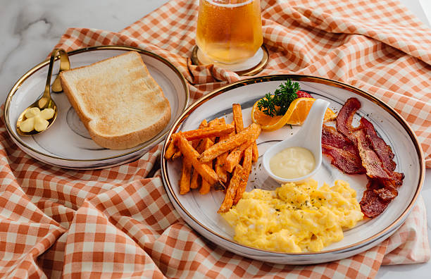 Delicious Breakfast with Scrambled Eggs, Bacon, Sweet Potatoes, Toast