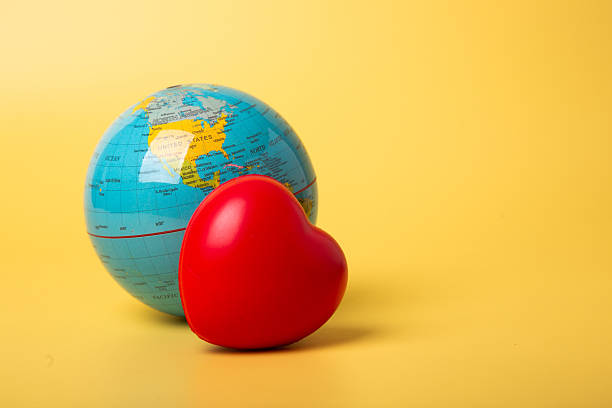 Red heart and globe showing world love concept