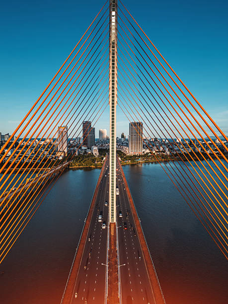 Symmetric modern cable-stayed bridge over Han River in Da Nang, Contemporary urban span connecting city skyline across Vietnamese waterway