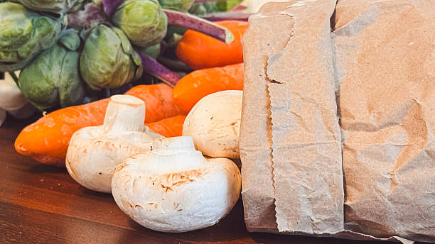 Organic vegetables from a local farm market sit on a kitchen table.