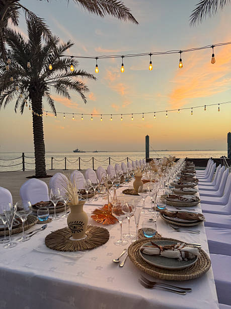 istock Elegant sunset gala banquet dinner table for outdoor seaside celebration wedding event with colorful sky 2260525416
