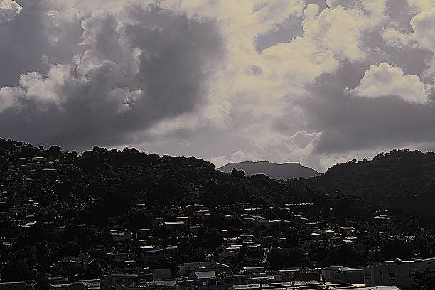 A hot, wet tropical storm in St Lucia, featuring rain, dark skies, and looming clouds