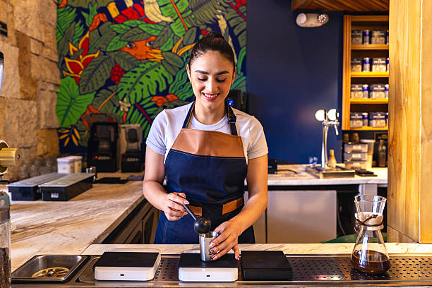 Smiling Barista Preparing Fresh Espresso in Modern Coffee Shop