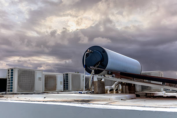 Solar hot water and cooling systems on hotel rooftop at sunrise