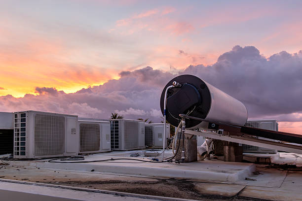 Sustainable hotel rooftop with hot water and cooling systems at sunrise