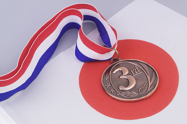 Flag of Japan under bronze medal. Japanese sport competition and winning medals.
