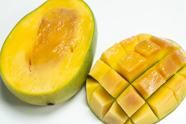 Close-up of overripe mango fruit with soft texture and dark spots