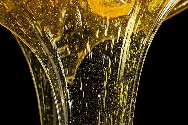 Luxury golden honey dripping on black background