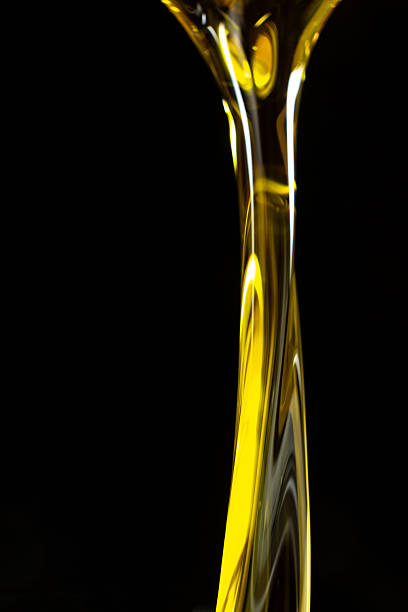 Vertical Abstract Background Flow Of Unrefined Oil On Black Background, Space For Text, Macro Texture