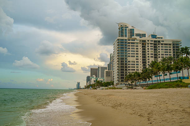 blue sky, beach day sunny day buildings in background sea, ocean waves and water Pompano beach Miami, FL, USA