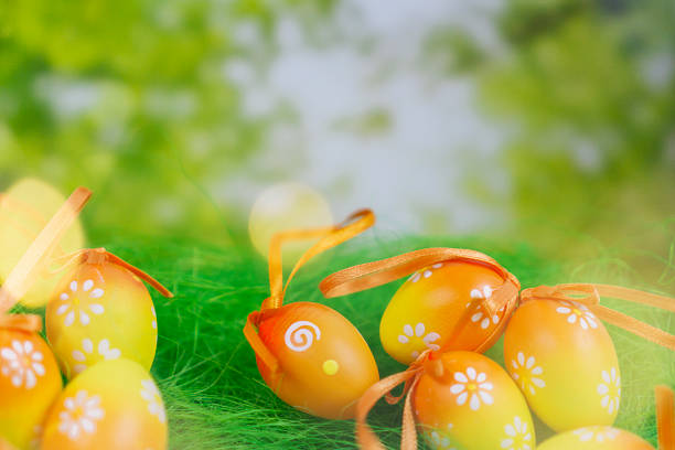 easter egg background spring yellow green grass colorful festive decoration season traditional holiday celebration ornament with copy space for banner design concept of family, spring, nature.