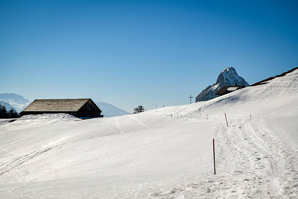Winter walking trail in Swiss Alps with beautiful view on Grosser Mythen peak in background