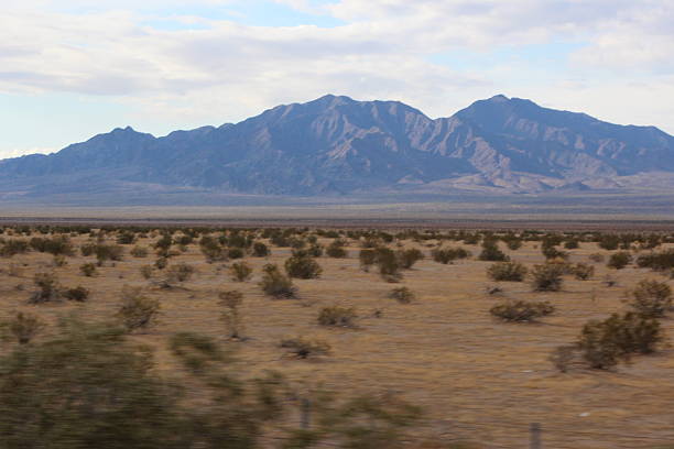 A desert view with a mountain in the background in California.