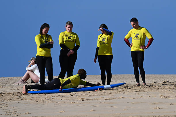 A surf instructor from the “Wellenkind Surf School” gives surfing lessons (here paddling) on the popular fine sandy Matorral Beach between Morro Jable and Jandia Playa on the south coast of Fuerteventura.