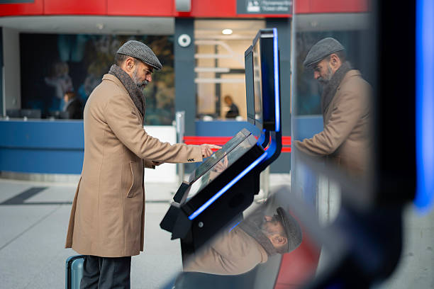 istock Mature adult using self service check-in kiosk at airport 2260586601