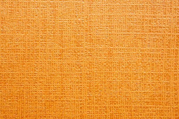 Texture old craft orange and yellow paper background, macro. Vintage abstract ginger cardboard with gradient and rainbow, rays pattern.