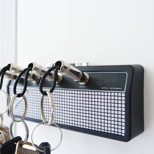 Creative Guitar Amp Key Holder with Jack Plug Keychains on White Wall