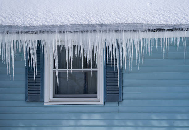 winter house with icicle and snow on the roof