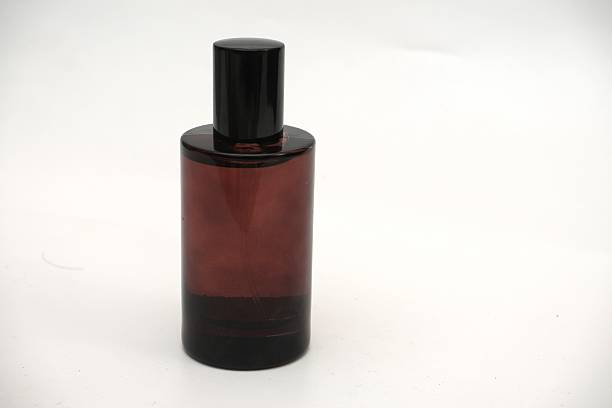 Dark green perfume spray bottle isolated on black background