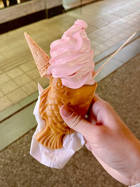 Warm bungeoppang filled with creamy ice cream, blending crisp pastry and cold, smooth sweetness. A delightful contrast of textures that feels playful, indulgent, and visually charming.