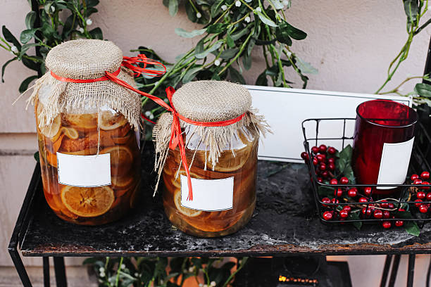 Cozy seasonal decoration with red berries. Traditional food storage and winter preparation concept.