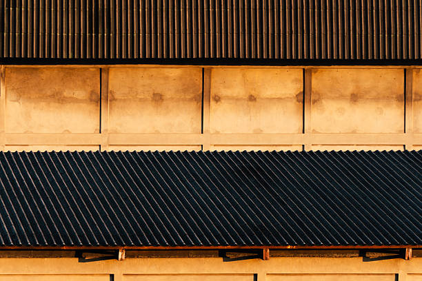 cement building with brown black roof with sunlight morning